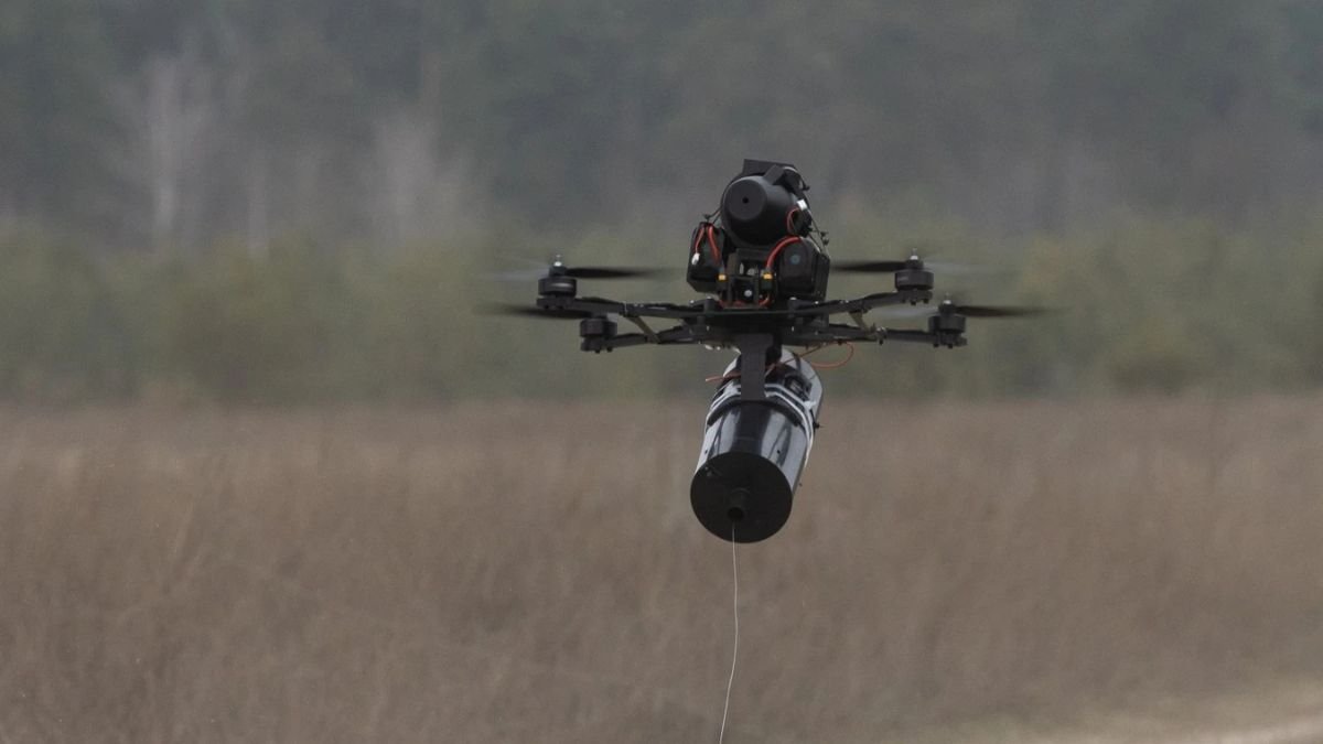 Fiber-optic first-person-view drone using a physical cable link to resist electronic jamming in contested battlefield environments