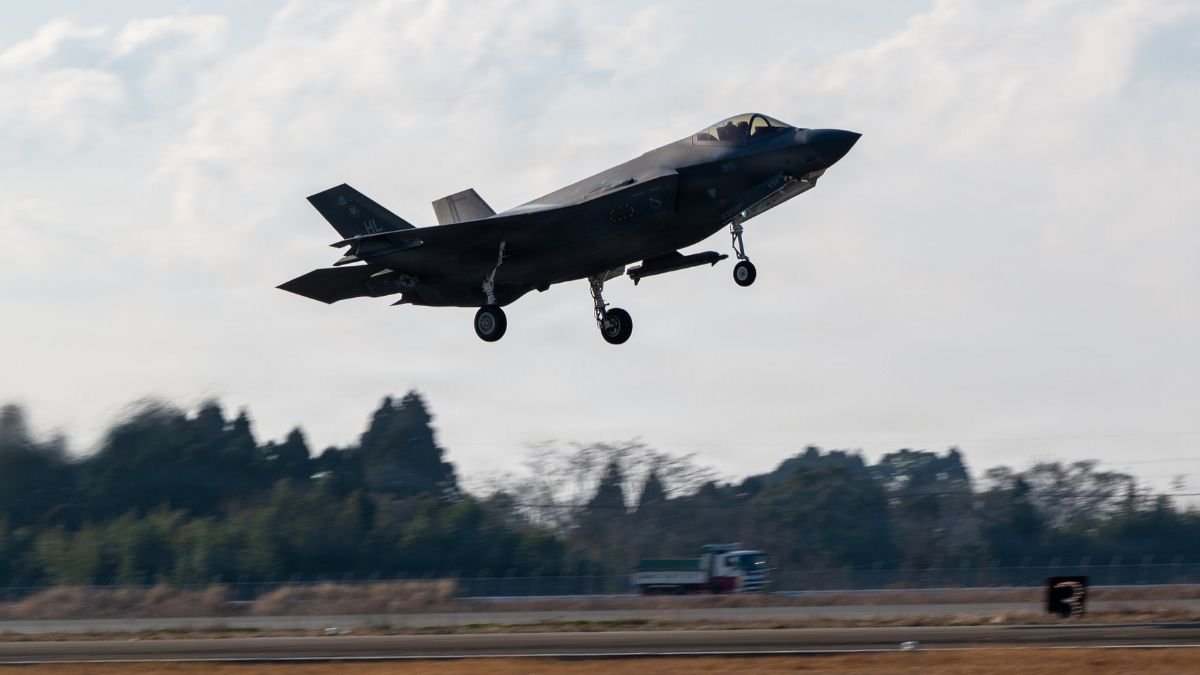 Military aircraft taking off representing Japan's military transformation and rearmament in response to Indo-Pacific security challenges