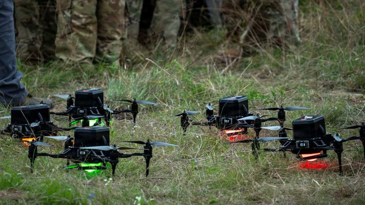 Military drone swarm preparing for deployment representing the US-China military AI competition and autonomous drone swarm capability development