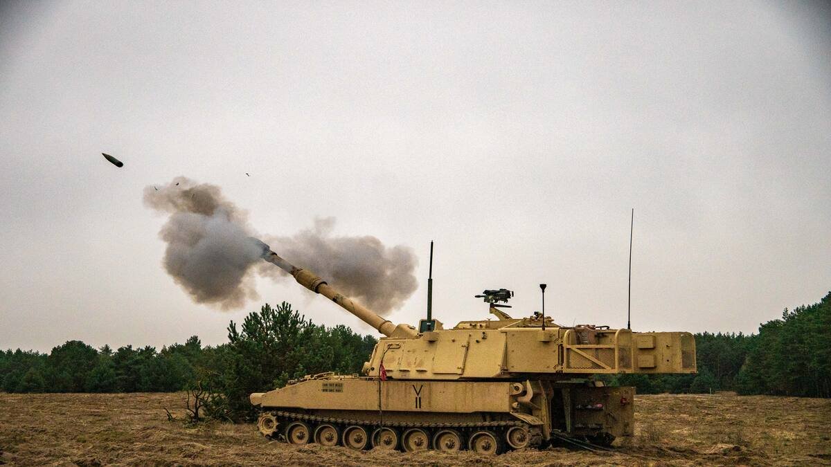 M109 Paladin self-propelled howitzer firing an artillery round during a military exercise